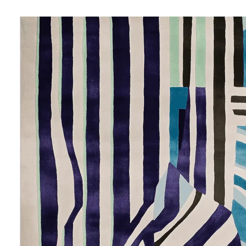 A contemporary area rug with bold, vertical stripes in shades of navy, teal, and black against a cream background. This wool rug, perfect for adding a modern touch to any living room, is a striking example of living room area rugs that combine style and functionality.
