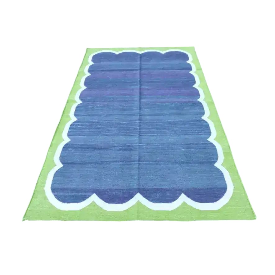 A vibrant Vegetable Dyed Indian Dhurrie Cotton Rug featuring rich blue and green hues, perfect as an area rug for the dining room or living room. This boho rug adds a touch of elegance and style, ideal for use as a dining table rug or as a centerpiece in rugs for living room settings.