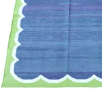 A vibrant Vegetable Dyed Indian Dhurrie Cotton Rug in blue and green, perfect as an area rug for a boho-style living room or dining room. The rug's unique pattern and color scheme add a touch of elegance, making it an ideal choice for a dining table rug or other cotton rugs in your home.