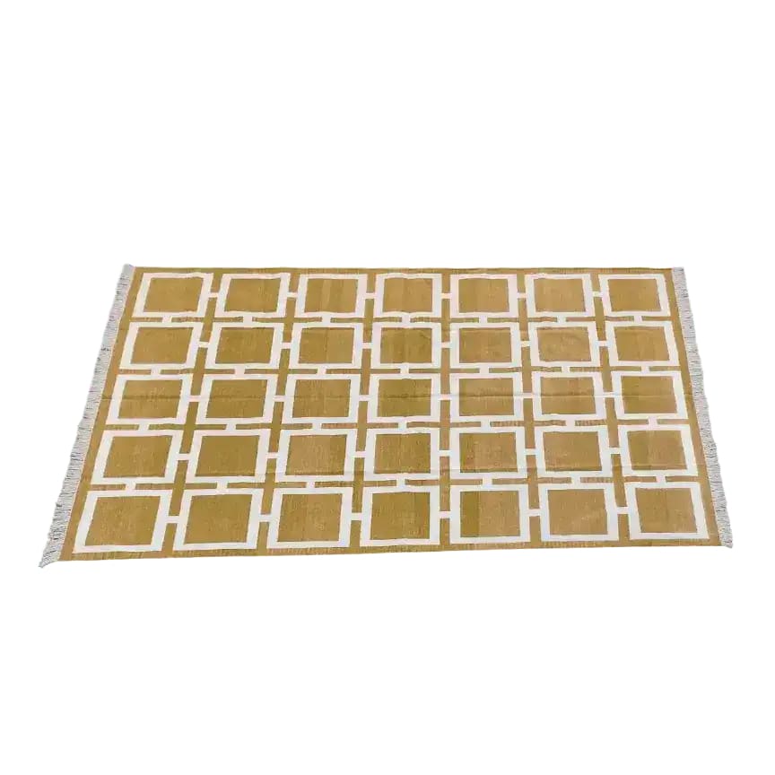 Top view of a Vegetable Dyed Indian Dhurrie Cotton Rug featuring a Medina Square pattern. This boho area rug is perfect for adding a touch of elegance to your dining room or living room. The intricate design and natural cotton material make it an ideal choice for formal dining room settings or as a stylish area rug for the living room.