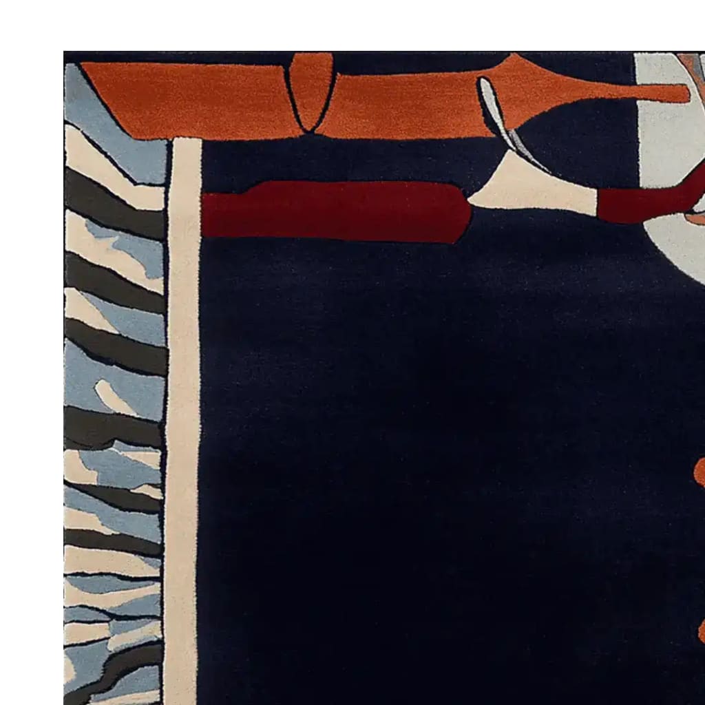 Top view of a contemporary hand-tufted wool area rug, featuring a bold abstract design with navy, orange, and red hues, ideal for large living rooms.