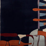 A contemporary wool area rug with an abstract design featuring deep navy, orange, and light blue hues, ideal for large living room spaces.
