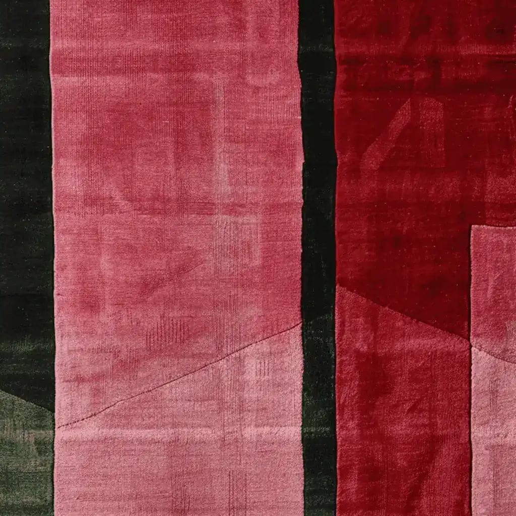 Close-up view of the Velvet Stripe Tension Hand Tufted Rug, showcasing its bold abstract design with rich red and pink hues. This contemporary area rug adds a stylish touch to any living room, crafted from luxurious wool for a modern feel.