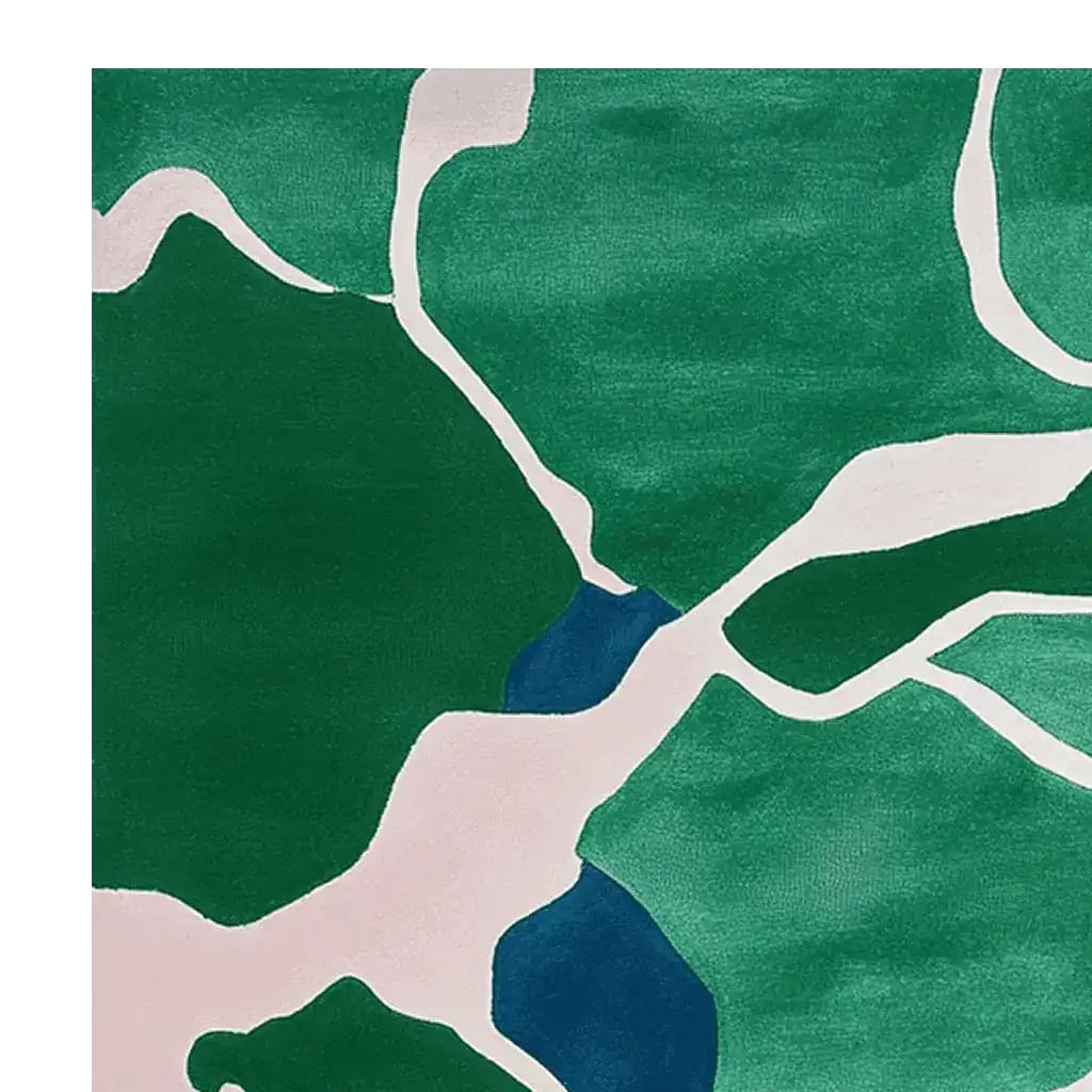 A close-up view of the Verdant Echo Flow Hand Tufted Rug, showcasing an abstract design with rich green and white patterns. This contemporary area rug is ideal for large living rooms, offering a touch of modern elegance. Made from high-quality wool, it's perfect for those seeking luxurious rugs for the living room.