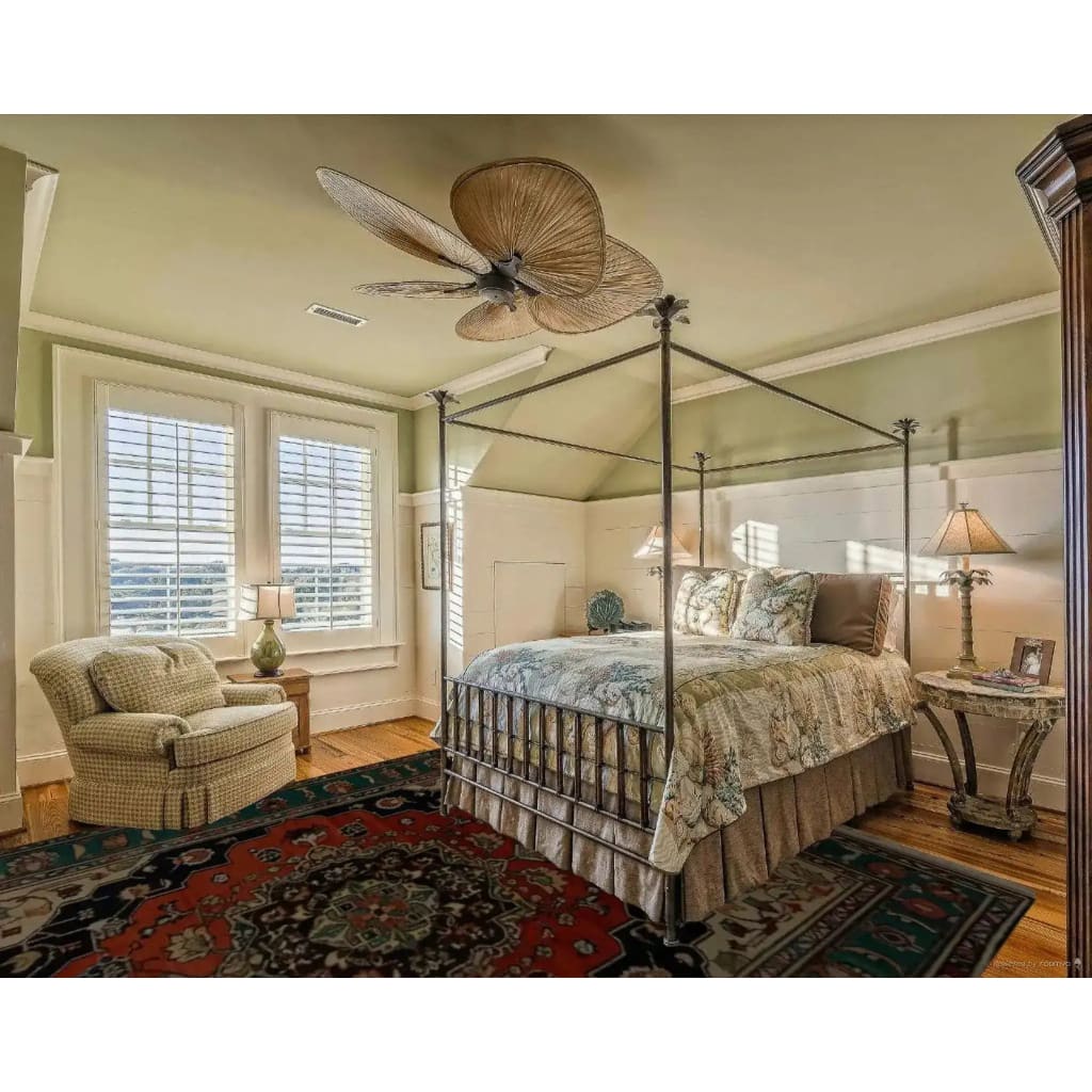 A cozy bedroom featuring a Verdant Haven Hand Knotted Area Rug. This vintage-inspired floral rug, reminiscent of Persian rugs, adds warmth and elegance to the room. The wool rug's intricate design and rich colors perfectly complement the living room setup, making it ideal for an 8x10 space.