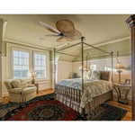 A cozy bedroom featuring a Verdant Haven Hand Knotted Area Rug. This vintage-inspired floral rug, reminiscent of Persian rugs, adds warmth and elegance to the room. The wool rug's intricate design and rich colors perfectly complement the living room setup, making it ideal for an 8x10 space.