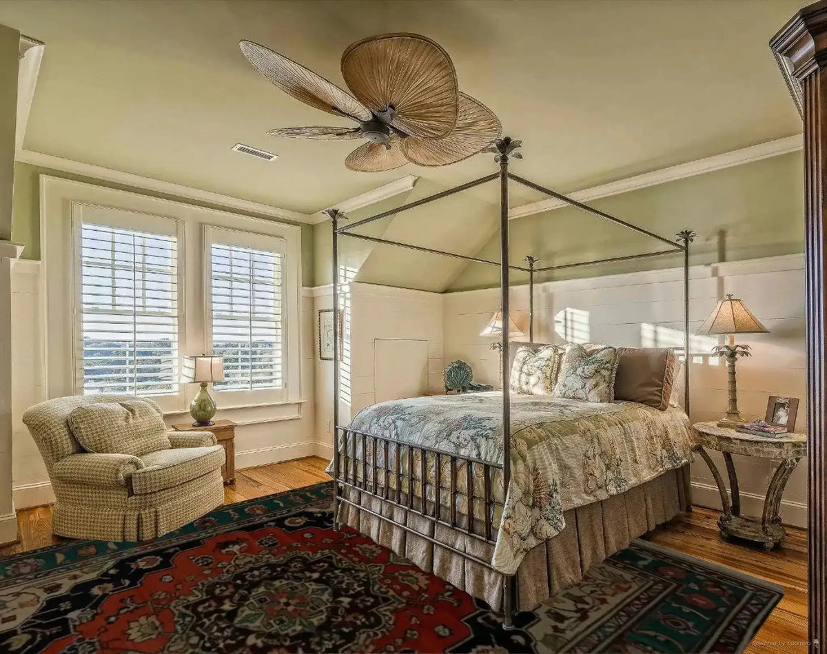 A cozy bedroom featuring a Verdant Haven Hand Knotted Area Rug. This vintage-inspired floral rug, reminiscent of Persian rugs, adds warmth and elegance to the room. The wool rug's intricate design and rich colors perfectly complement the living room setup, making it ideal for an 8x10 space.