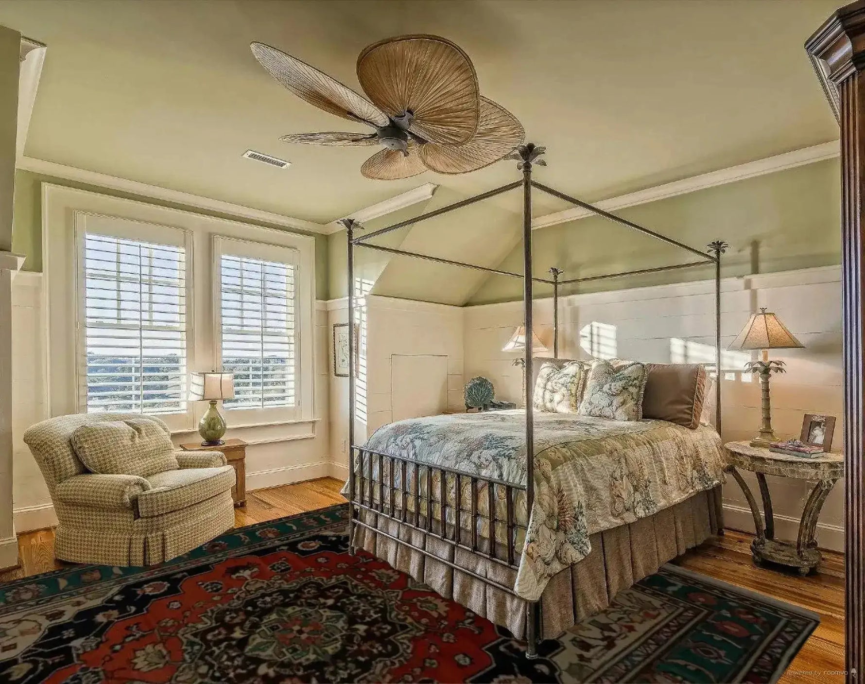 A cozy bedroom featuring a Verdant Haven Hand Knotted Area Rug. This vintage-inspired floral rug, reminiscent of Persian rugs, adds warmth and elegance to the room. The wool rug's intricate design and rich colors perfectly complement the living room setup, making it ideal for an 8x10 space.