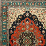 Detailed view of the Verdant Haven Hand Knotted Area Rug showcasing its intricate Persian floral design. The rug features a vibrant mix of colors with rich red, deep blue, and lush green hues, typical of vintage rugs. Ideal as an 8x10 wool rug for living rooms, it brings a classic touch to any space.