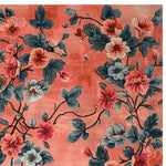 The Verdant Retreat Hand Knotted Rug features a stunning floral design with vibrant pink and blue flowers, perfect for adding a touch of elegance to large living room spaces. This wool area rug is ideal for both the bedroom and living room, sized at 8x10, offering a beautiful blend of colors and craftsmanship.