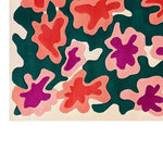 Vibrant area rug with an abstract floral pattern in shades of red, pink, and green, perfect for large living room spaces. This contemporary wool rug adds a pop of color and style, showcasing a hand-tufted design for a modern aesthetic.