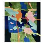 The Verdant Terrain Collage Hand Tufted Rug showcases a vibrant abstract design with a mix of green, blue, orange, pink, and teal colors. Ideal for adding a contemporary touch to large living rooms, this wool area rug combines artistic flair with functionality, making it a perfect choice for those seeking unique and stylish living room area rugs.