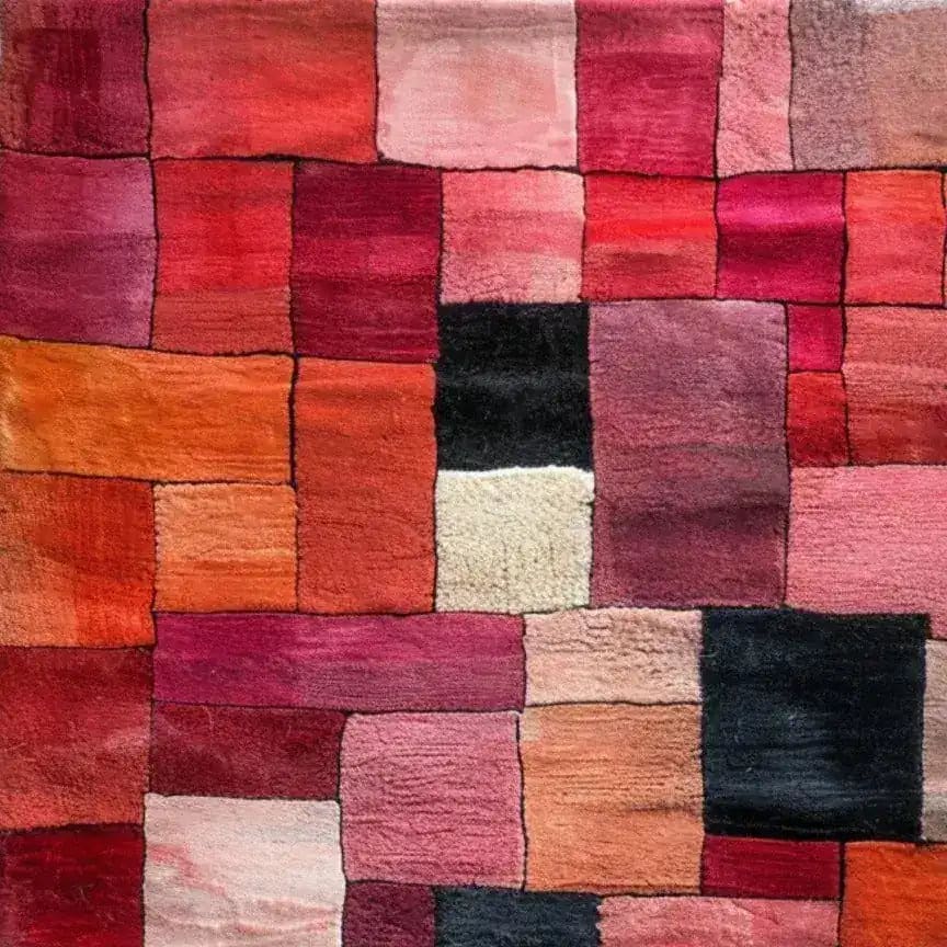A vibrant Vermilion Grid Hand Tufted Area Rug featuring a striking patchwork of red, pink, and orange hues. This contemporary wool rug is perfect for adding a pop of color to your living room. Ideal for those looking for large area rugs to enhance their space with a modern touch.
