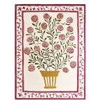 Top view of a Vibrant Bloom Cascade Hand Tufted Wool Rug, featuring a detailed floral pattern with a central potted plant design. This area rug, ideal for large living rooms, showcases a contemporary style in shades of green and pink, perfect as a wool rug for an 8x10 living room setting.