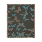 Vibrant Butterfly Woven Blanket charcoal back with scattered teal and gray butterfly silhouettes and fringed edging all around