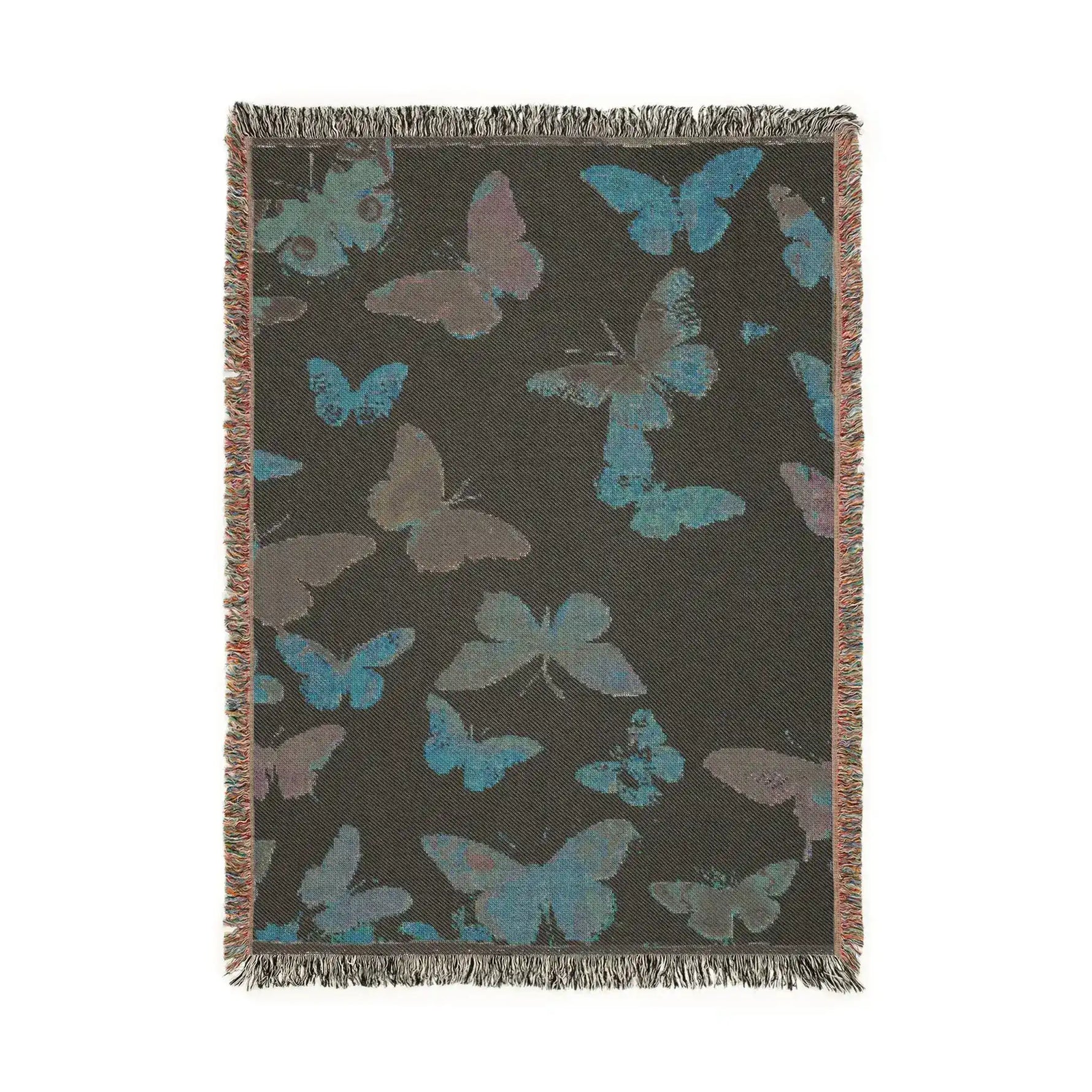 Vibrant Butterfly Woven Blanket charcoal-dark reverse side showing teal and gray-purple butterfly silhouettes woven on dark ground with fringed edges