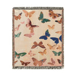 Vibrant Butterfly Woven Blanket displayed in bathroom showing golden hen with round sunglasses, pearl necklace, floral embroidered collar on dark background