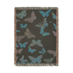 Vibrant Butterfly Woven Blanket hung on clothesline displaying a proud lion in round dark sunglasses and ornate red-gold baroque jacket on dark background