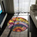 Flamingo Rainbow Round Rug close-up on dark floor showing pink flamingos, rainbow arcs and tropical leaf details