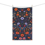 Vibrant Floral Embroidered Cotton Kitchen Towel on clothesline with full-length orange, lavender and pink botanical floral on dark navy