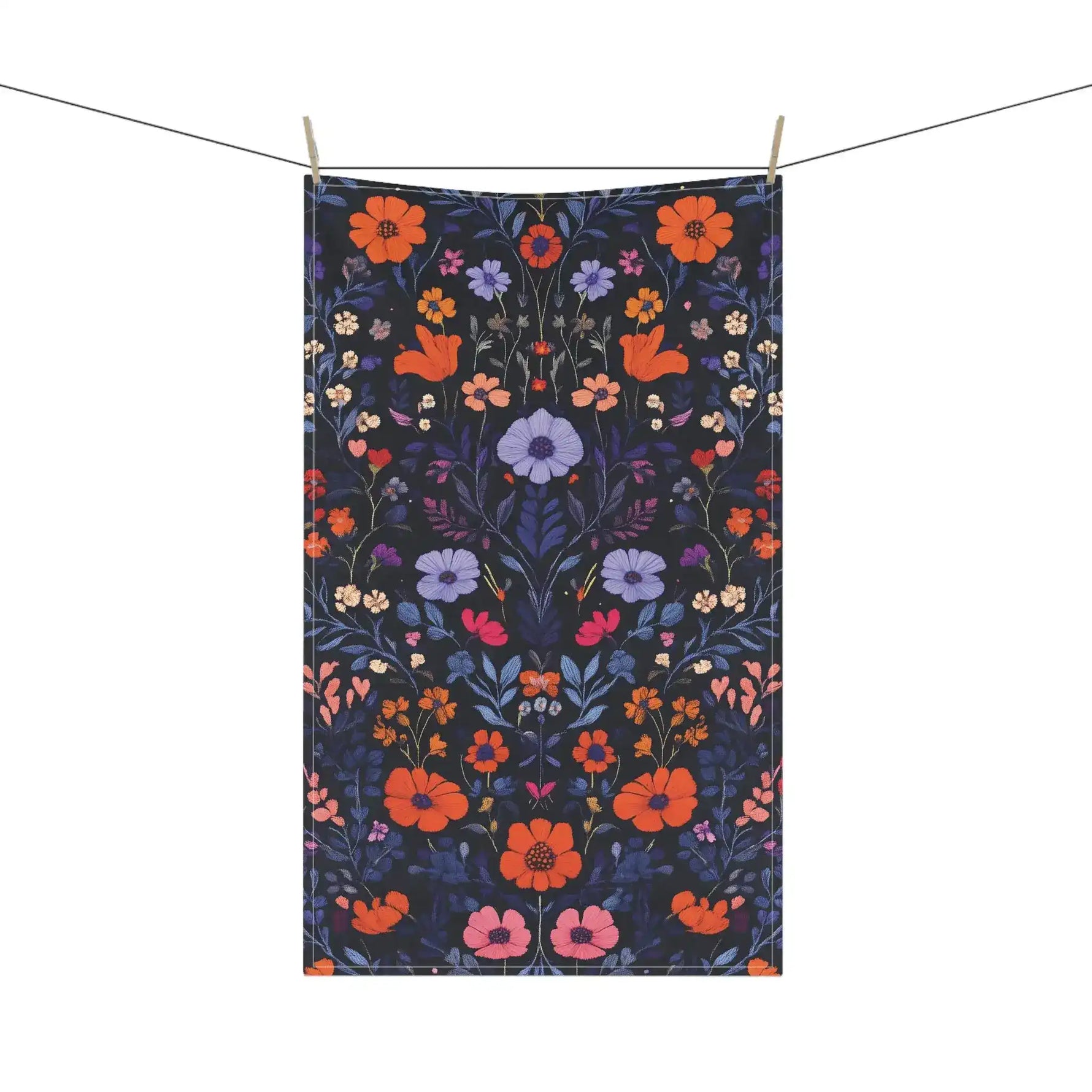 Vibrant Floral Embroidered Cotton Kitchen Towel on clothesline with full-length orange, lavender and pink botanical floral on dark navy