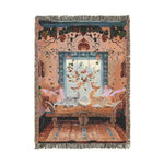 Woven tapestry blanket depicting two cats lounging on an ornate chaise near a window in a floral bohemian room, fringed border on the Vibrant Floral and Feline Woven Blanket