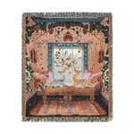 Folded corner of the Vibrant Floral and Feline Woven Blanket showing bold blue and white abstract organic blob pattern with grey anti-slip backing