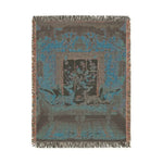 Portrait-format dark teal-grey woven version of cats lounging on chaise in a floral room with knotted fringe on the Vibrant Floral and Feline Woven Blanket