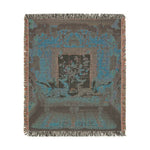 Square-format dark teal inverted woven tapestry of cats on an ornate chaise in a botanical room with fringe on the Vibrant Floral and Feline Woven Blanket