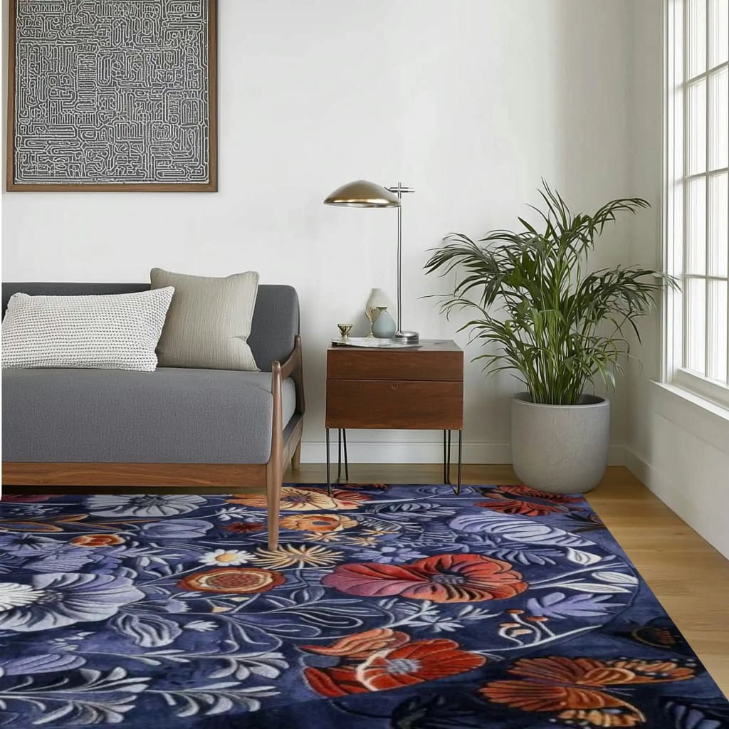 A beautifully vibrant floral area rug adorns a stylish living room, featuring a vivid array of colorful flowers on a deep navy background. This hand-tufted wool rug enhances the modern decor, complementing the sleek gray sofa and wooden side table. Ideal for large living room spaces, this floral rug adds a touch of elegance and warmth.