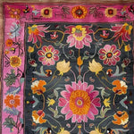 A vibrant floral tapestry hard viscose hand-knotted wool rug showcasing an intricate design with pink, orange, and yellow flowers against a dark background. Perfect for large living rooms, this Persian-style area rug adds a vintage touch to any space, ideal for those seeking 8x10 living room rugs or large area rugs.