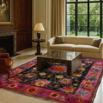 A vibrant floral tapestry area rug in a large living room, featuring intricate Persian-inspired designs. This wool rug, perfect for living room spaces, showcases a colorful pattern with pink and black hues, adding a vintage charm to the setting. Ideal for those seeking large area rugs or living room rugs 8x10.