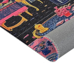Folded corner of the Vibrant Maximalist Floral Rug with pink floral field and gold-framed coffee table base visible in background