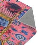 Corner fold of the Vibrant Maximalist Floral Rug showing pink rose floral pattern on face and grey non-slip woven backing underneath