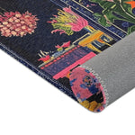 Rolled corner of the Vibrant Maximalist Floral Rug revealing grey backing, dark navy field with bold pink and coral floral print on face