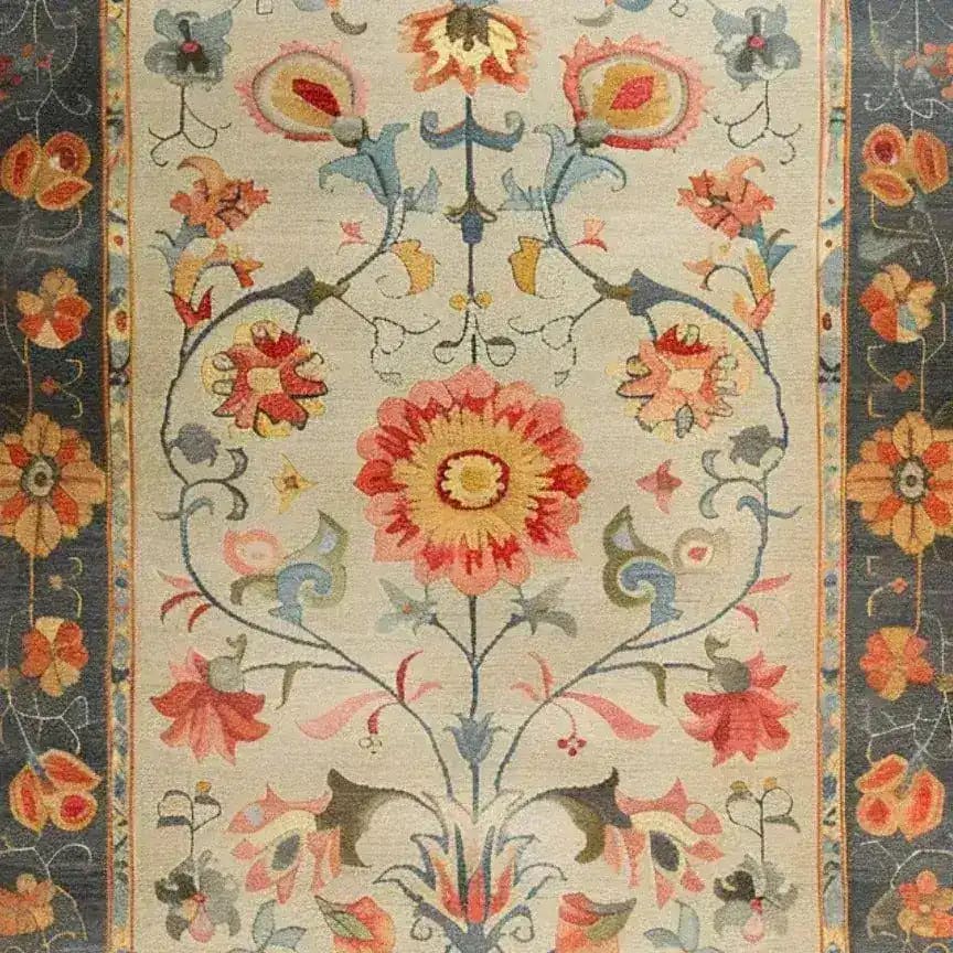 A beautifully detailed hand-knotted area rug featuring a vibrant floral design, reminiscent of traditional Persian rugs. This large living room rug, perfect for an 8x10 space, showcases intricate patterns with red, blue, and gold tones, creating a striking centerpiece for any modern interior.