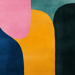 A vibrant mosaic pattern hand tufted wool rug featuring bold geometric shapes in pink, blue, yellow, and green. This contemporary area rug is ideal for adding a pop of color to dining room or living room spaces.