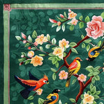 Vibrant vintage hand-tufted area rug featuring a detailed floral and bird design. The wool rug showcases colorful birds perched among blooming flowers against a rich green background, perfect for adding a touch of elegance to any living room. This square area rug is ideal for those seeking large area rugs for living room spaces.