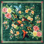 A vibrant vintage hand-tufted area rug featuring colorful birds and blooming flowers on a green background. This wool rug, perfect for a living room, showcases a square design ideal for large area spaces, adding a touch of elegance to any setting.