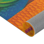 Rolled corner detail showing orange fish scale texture and blue stripe of the Vibrant Vision Surreal Girl & Multicolor Fish Art rug with grey non-slip backing