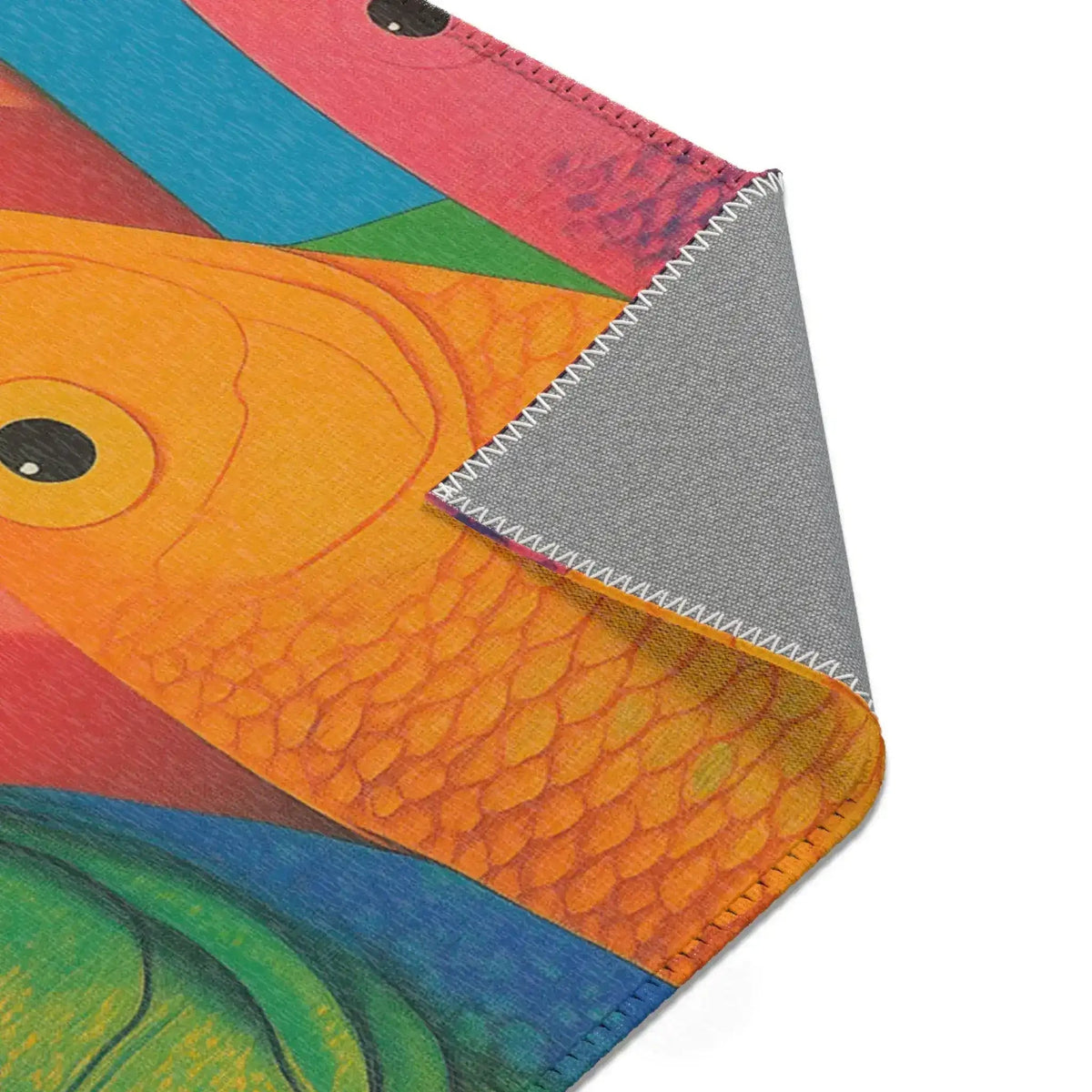 Colorful woven tapestry with gradient red-orange-pink-purple wave bands and dark navy fringe on the Vibrant Vision Surreal Girl & Multicolor Fish Art rug