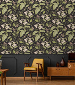 Dark floral wallpaper with white hydrangea blooms above charcoal panelling with yellow chair and sideboard