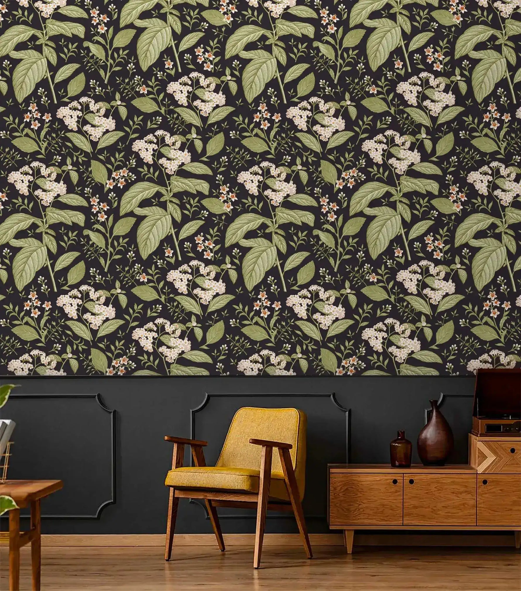 Dark floral wallpaper with white hydrangea blooms above charcoal panelling with yellow chair and sideboard
