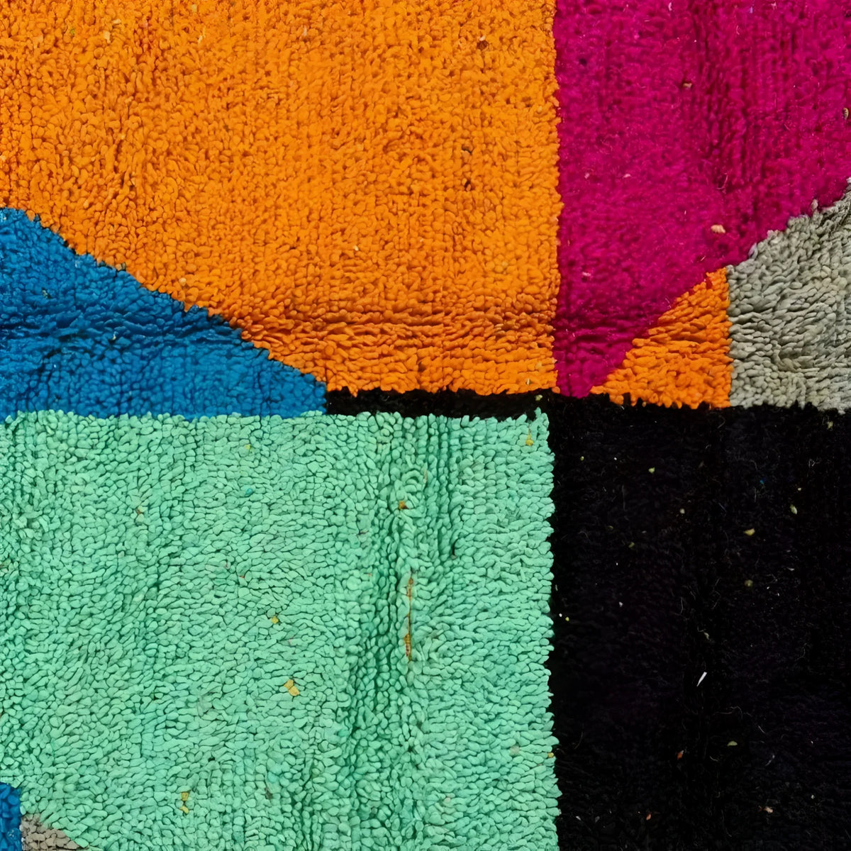 Close-up view of a vibrant Vinai Moroccan Berber handwoven colorful runner rug showcasing bold geometric patterns with rich colors like orange, teal, blue, and pink. Ideal for use as a kitchen rug, wool rug, bathroom runner rug, hallway runner rug, or kitchen runner rug.