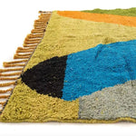 Close-up view of the Vinai Moroccan Berber Handwoven Colorful Rug showcasing its vibrant colors and detailed texture. This runner rug features a blend of blue, black, green, and orange hues, making it an ideal choice for kitchen rugs, wool rug, bathroom runner rug, and hallway runner rug applications. The intricate fringe detail adds a touch of elegance, perfect for kitchen runner rugs.