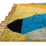Close-up view of the Vinai Moroccan Berber Handwoven Colorful Rug showcasing its vibrant colors and detailed texture. This runner rug features a blend of blue, black, green, and orange hues, making it an ideal choice for kitchen rugs, wool rug, bathroom runner rug, and hallway runner rug applications. The intricate fringe detail adds a touch of elegance, perfect for kitchen runner rugs.