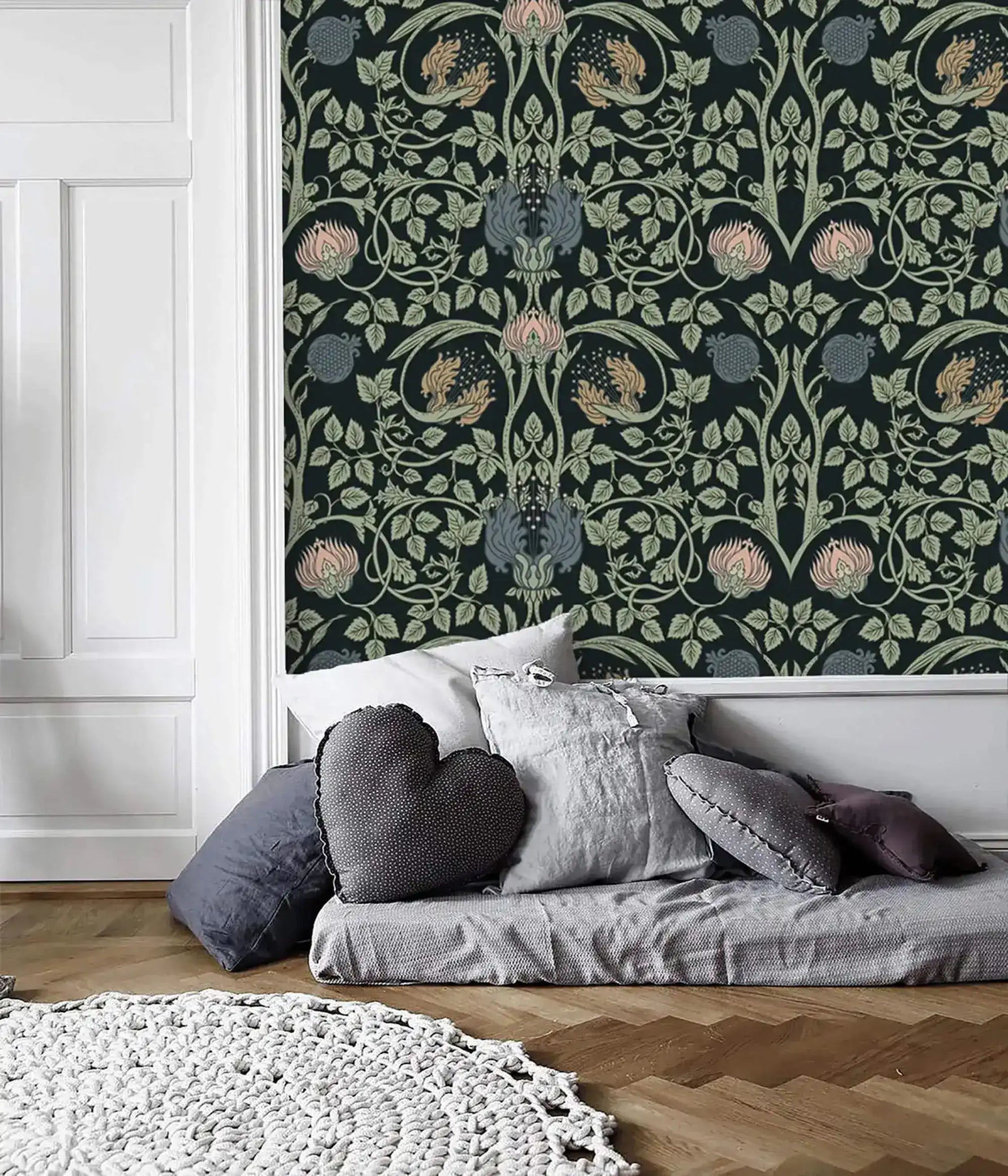Vine and flower wallpaper in deep teal with symmetrical green Art Nouveau vines and pink blooms; floor bed and white paneled wall