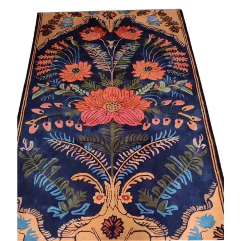 A vibrant vintage Aurum Garden hand-tufted area rug with a striking floral design. This wool rug features bold orange and blue flowers with intricate green leaves on a deep navy background, perfect for adding a touch of elegance to any living room. Ideal as a living room area rug in an 8x10 size, this piece combines classic vintage charm with beautiful floral patterns.