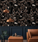 Vintage bird haven wallpaper with birds and blossoming branches on black above navy panelling with copper pendants