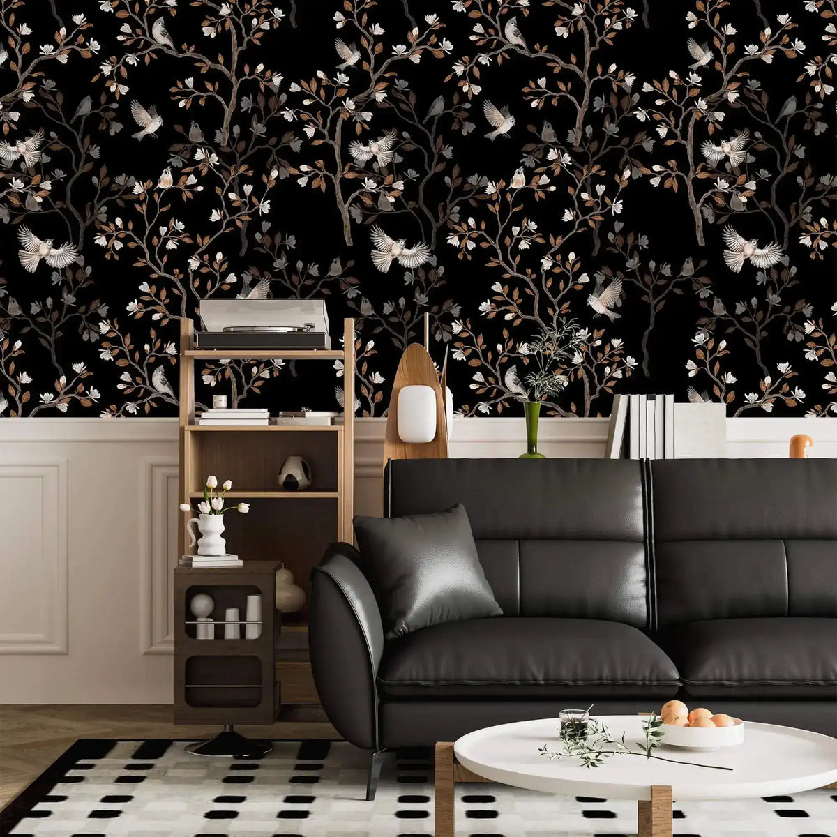 Vintage bird haven wallpaper with birds and blossoms on black above wainscoting in a living room with black sofa